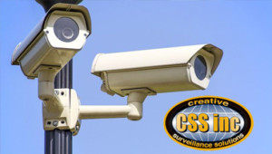 Two security cameras mounted to a pole.